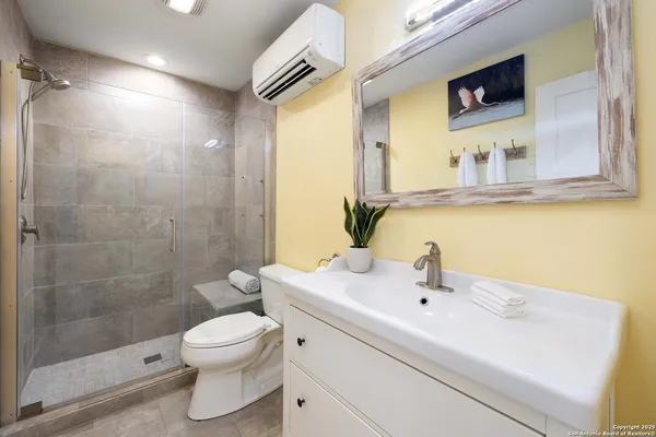 a bathroom with a sink toilet and shower