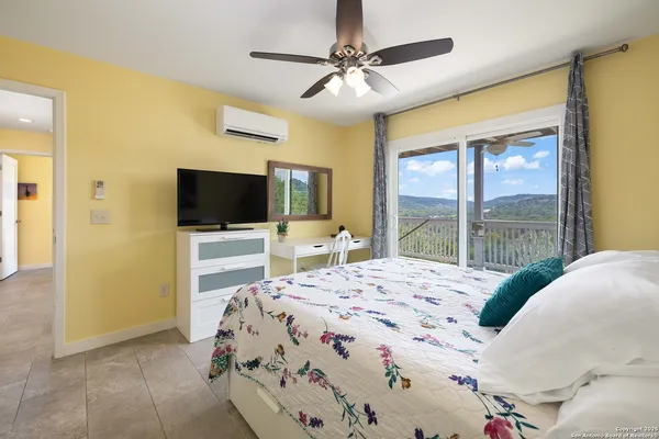 a bedroom with a bed and a flat screen tv