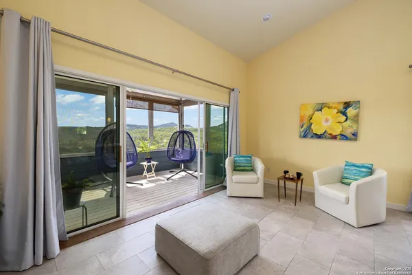 a living room with furniture and a floor to ceiling window
