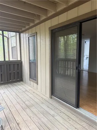 a view of a porch with wooden floor and stairs