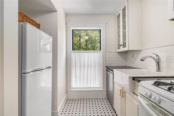 a kitchen with a refrigerator and a sink