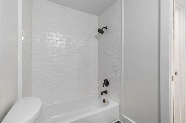 a bathroom with a bathtub and a toilet
