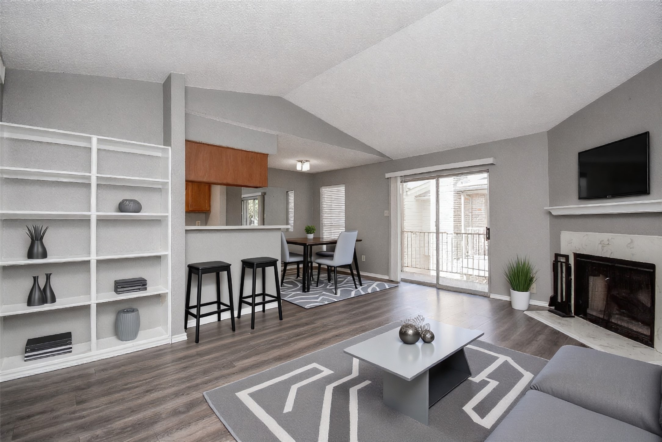 a living room with furniture a fireplace and a flat screen tv
