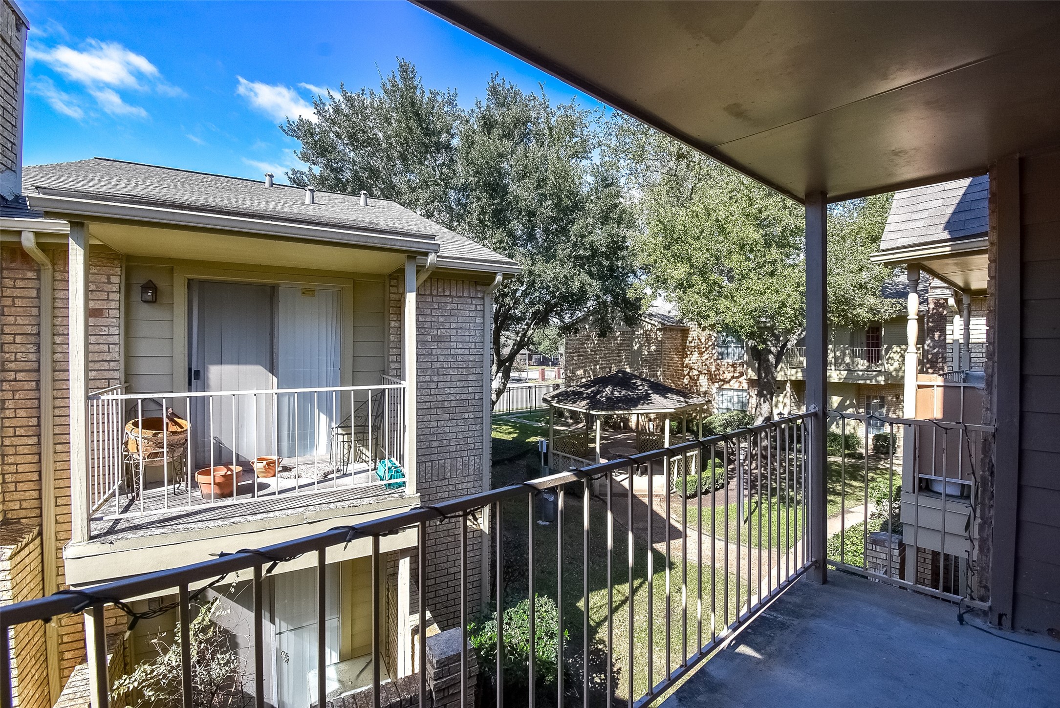 1515 Sandy Springs Road, Unit 1006 Houston, TX 77042 - Photo 20 of 35 a view of a house with a porch and furniture