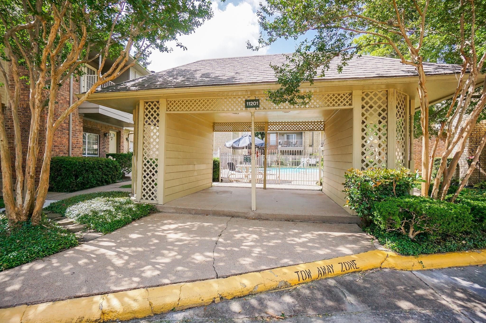 1515 Sandy Springs Road, Unit 1006 Houston, TX 77042 - Photo 27 of 35 a view of yellow house with a swimming pool