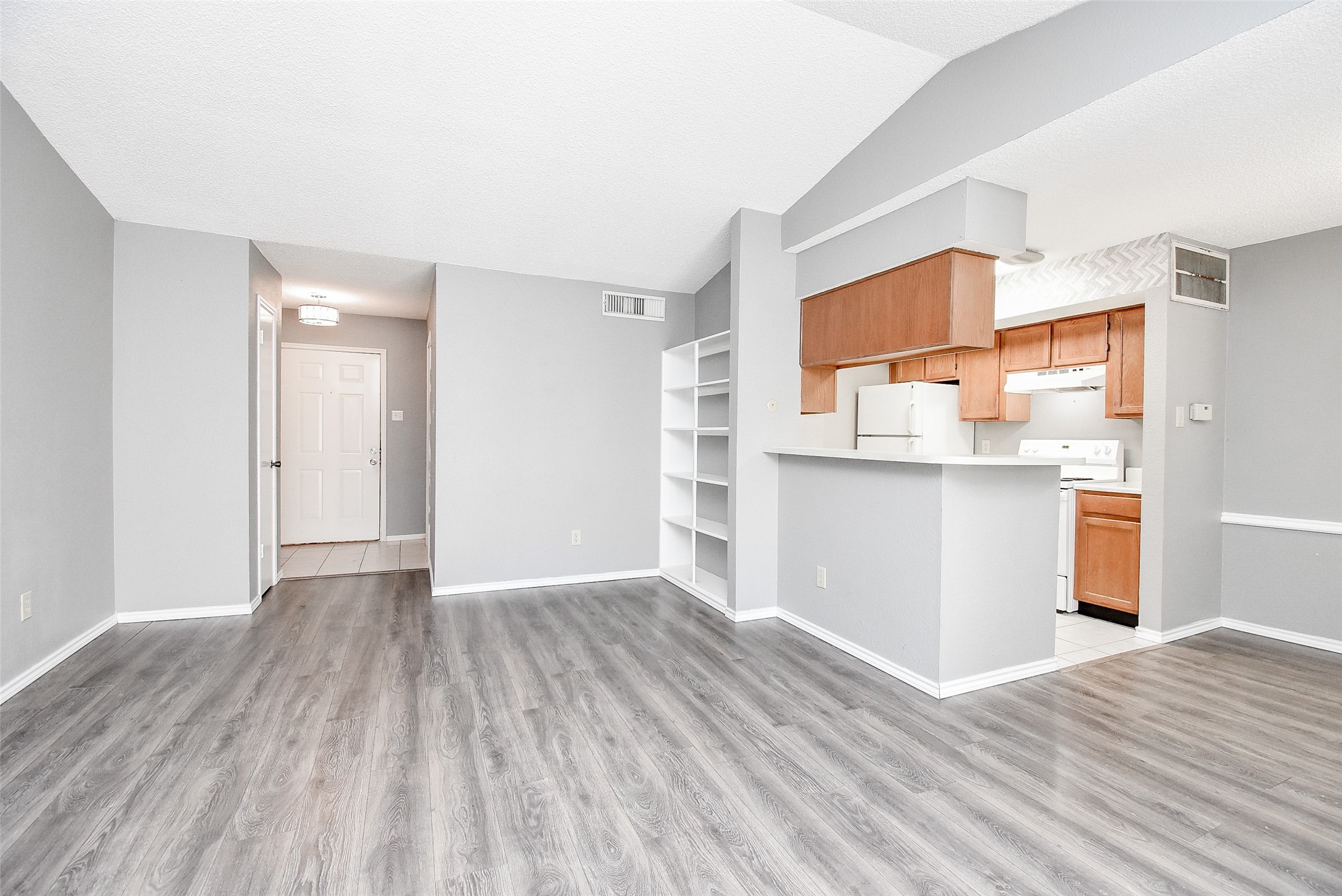 1515 Sandy Springs Road, Unit 1006 Houston, TX 77042 - Photo 3 of 35 a view of a kitchen with wooden floor and a sink