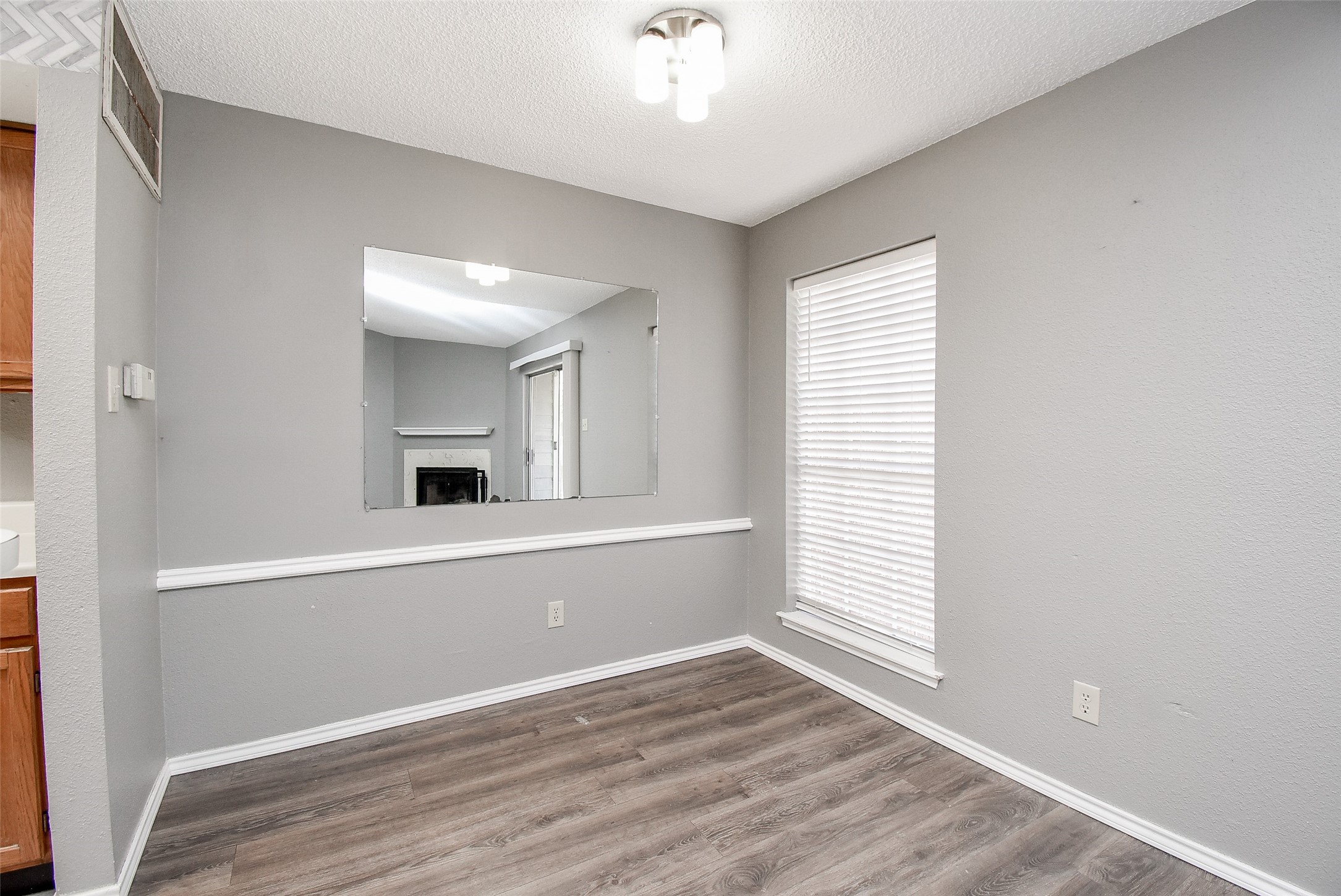1515 Sandy Springs Road, Unit 1006 Houston, TX 77042 - Photo 4 of 35 a view of a livingroom with wooden floor and a ceiling fan