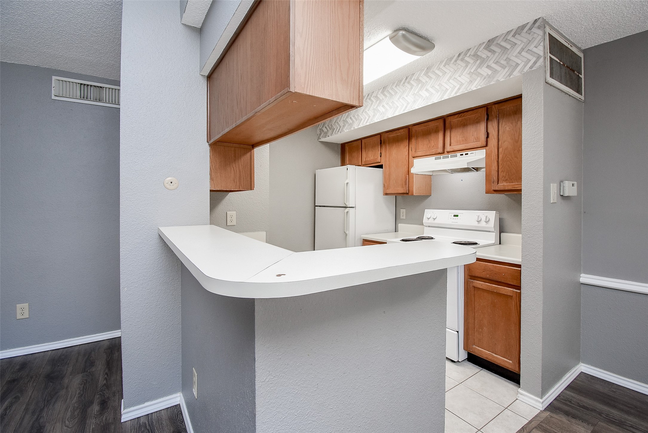 1515 Sandy Springs Road, Unit 1006 Houston, TX 77042 - Photo 6 of 35 a kitchen with stainless steel appliances a sink a stove and a refrigerator