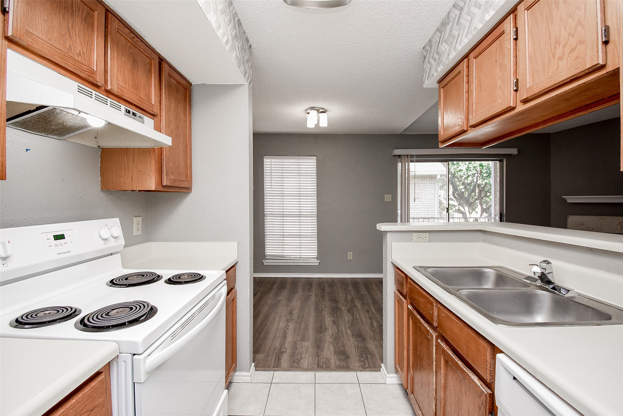 1515 Sandy Springs Road, Unit 1006 Houston, TX 77042 - Photo 9 of 35 a kitchen with a sink a stove and cabinets