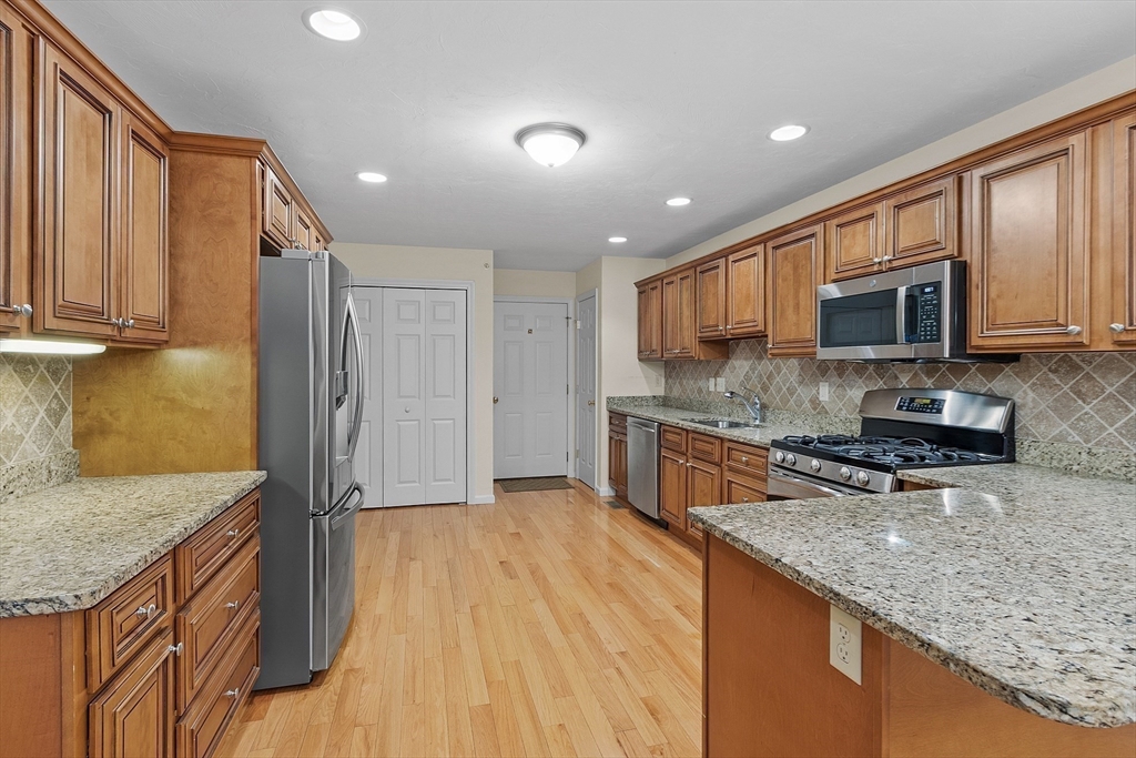 2 Riley Road, Unit C Lunenburg, MA 01462 - Photo 23 of 42 a kitchen with stainless steel appliances granite countertop a refrigerator a stove top oven and sink