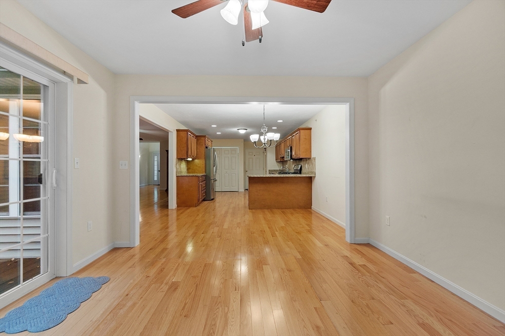 2 Riley Road, Unit C Lunenburg, MA 01462 - Photo 27 of 42 a view of a hallway with wooden floor and a kitchen