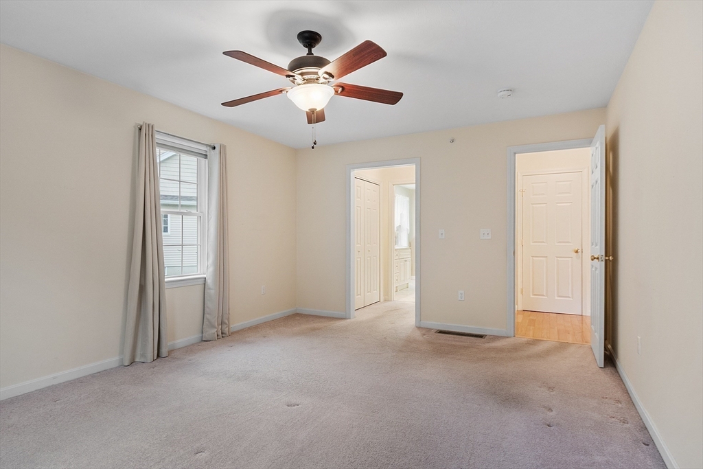 2 Riley Road, Unit C Lunenburg, MA 01462 - Photo 29 of 42 an empty room with closet and a chandelier fan