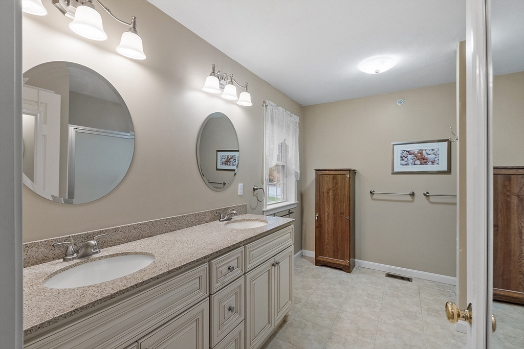 2 Riley Road, Unit C Lunenburg, MA 01462 - Photo 32 of 42 a spacious bathroom with double vanity sinks and a mirror