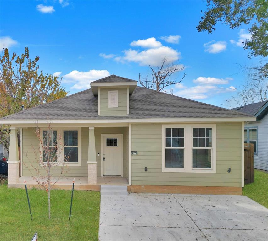 View of front of home with a front yard, a porch, and a shingled roof