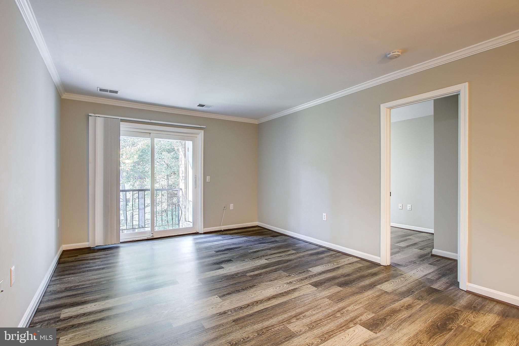 18324 Streamside Drive, Unit 302 Gaithersburg, MD 20879 - Photo 11 of 31 Family Room with Sliding Glass Door To Balcony