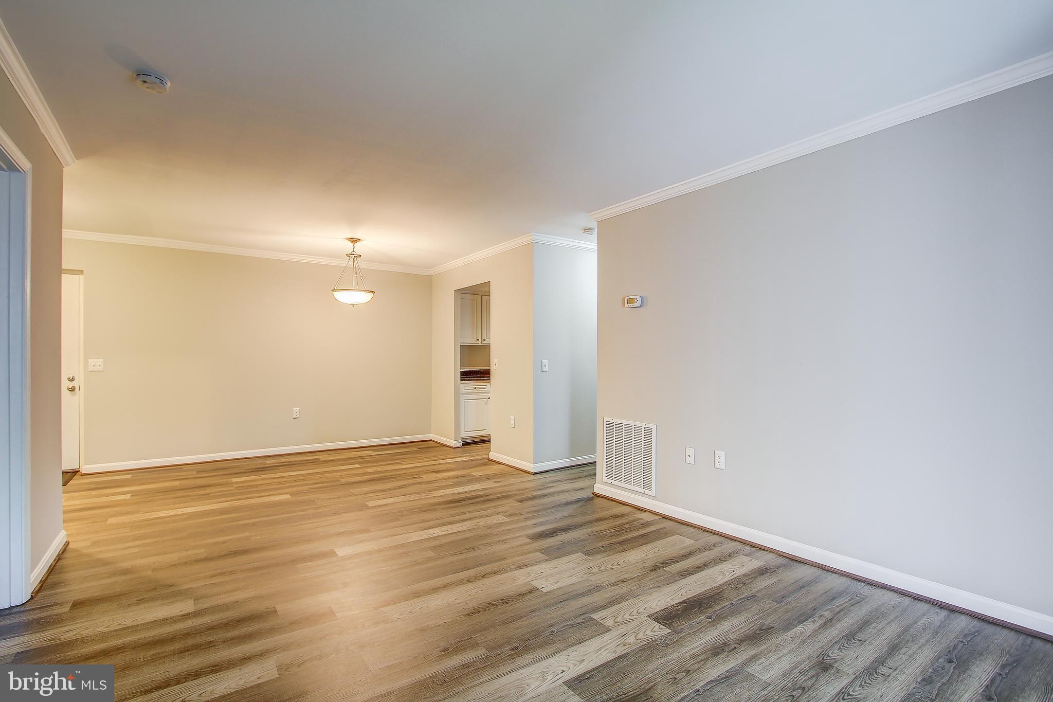 18324 Streamside Drive, Unit 302 Gaithersburg, MD 20879 - Photo 12 of 31 Family Room Opens to Dining Area
