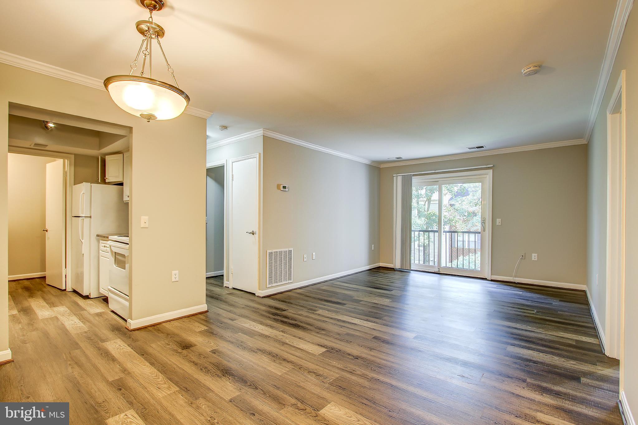 18324 Streamside Drive, Unit 302 Gaithersburg, MD 20879 - Photo 8 of 31 Family Room with Luxury Vinyl Plank Flooring