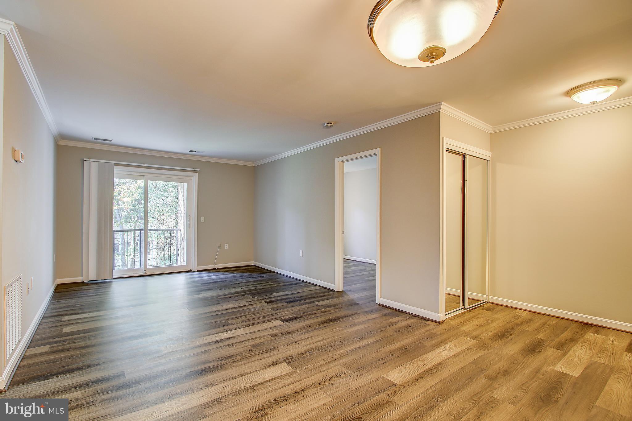 18324 Streamside Drive, Unit 302 Gaithersburg, MD 20879 - Photo 9 of 31 Family Room with Luxury Vinyl Plank Flooring