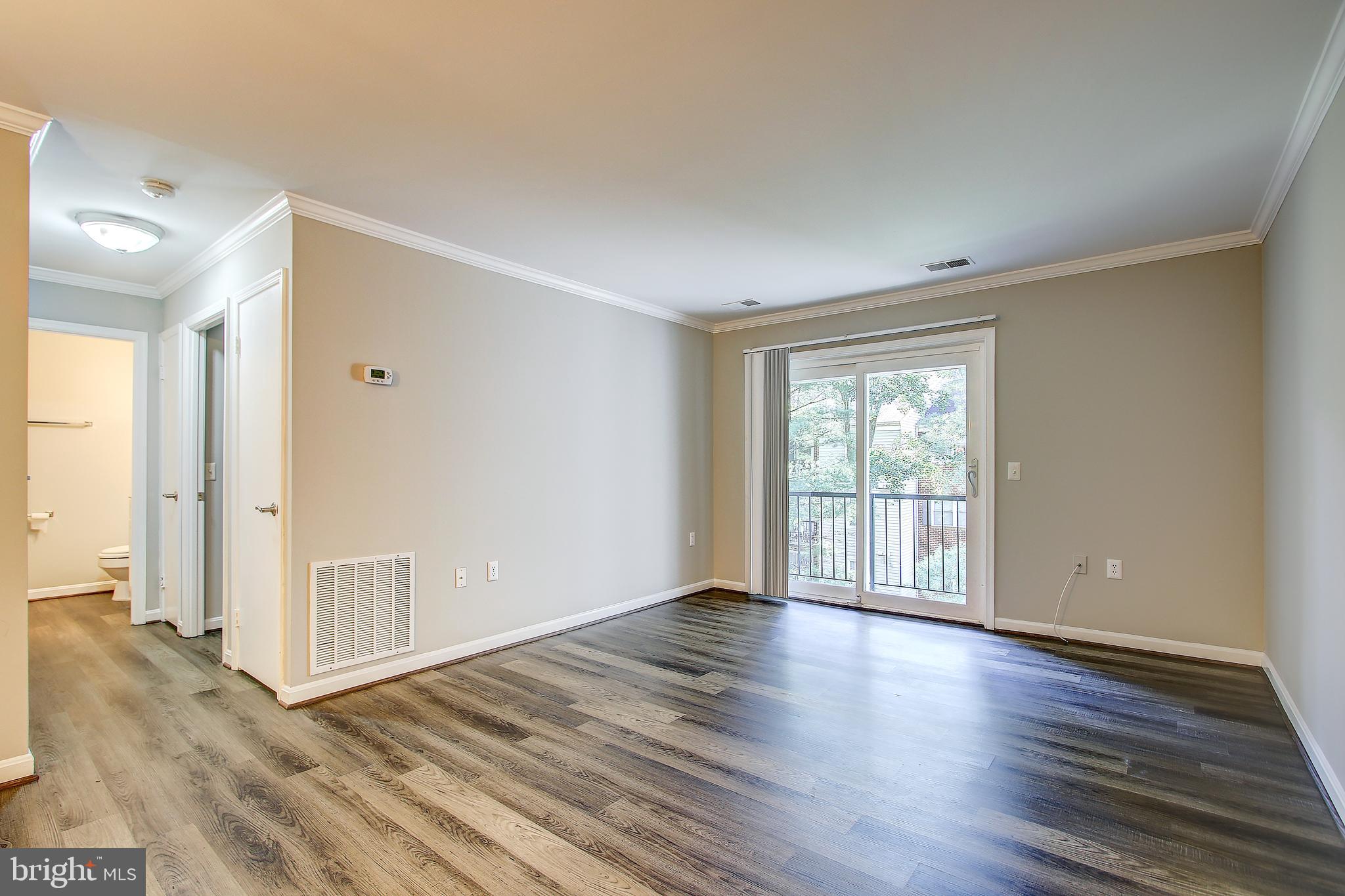 18324 Streamside Drive, Unit 302 Gaithersburg, MD 20879 - Photo 10 of 31 Family Room with Sliding Glass Door To Balcony