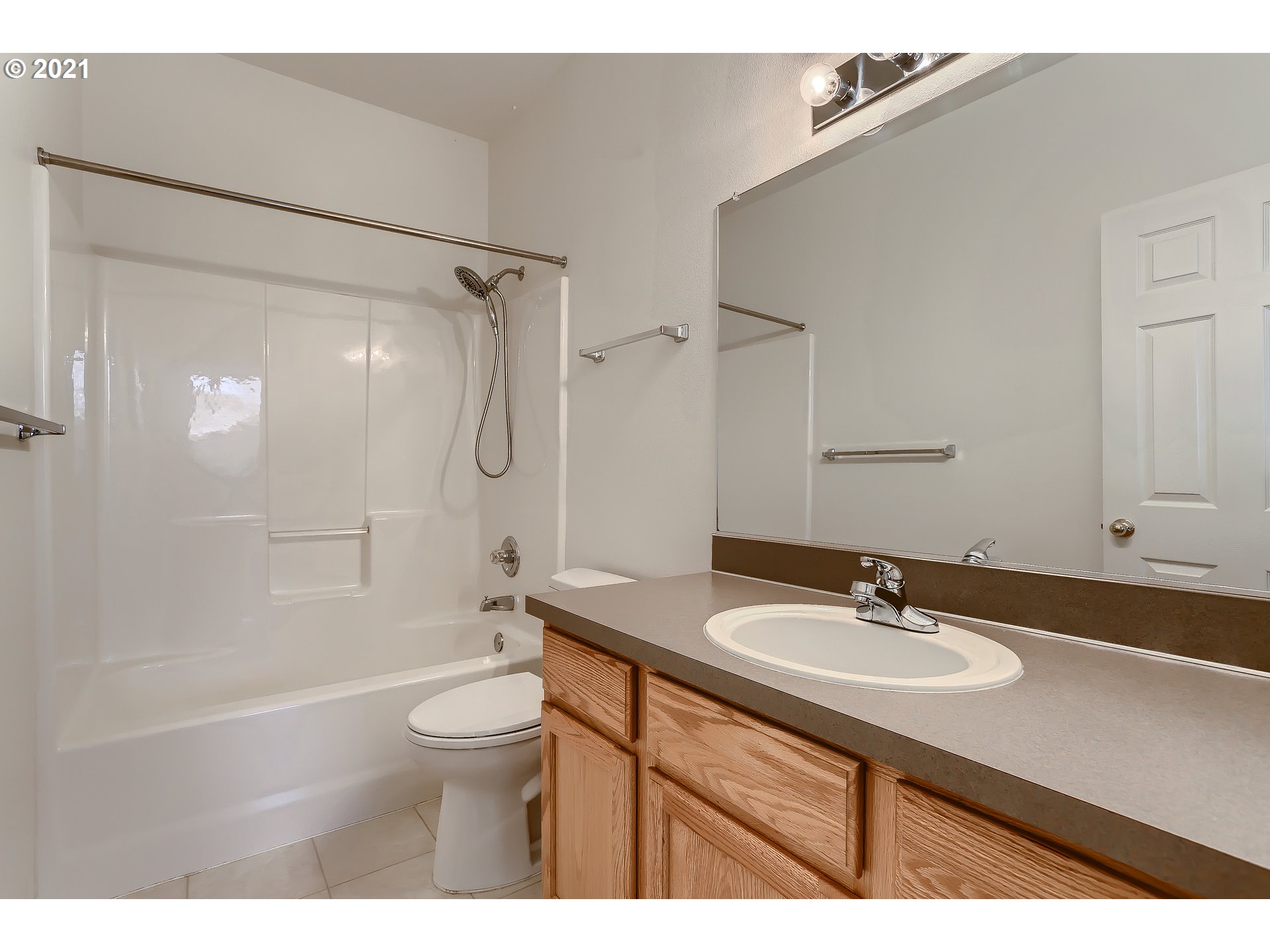7152 Southwest Manor Way, Unit F Aloha, OR 97078 - Photo 14 of 28 a bathroom with a sink a toilet a shower and a mirror