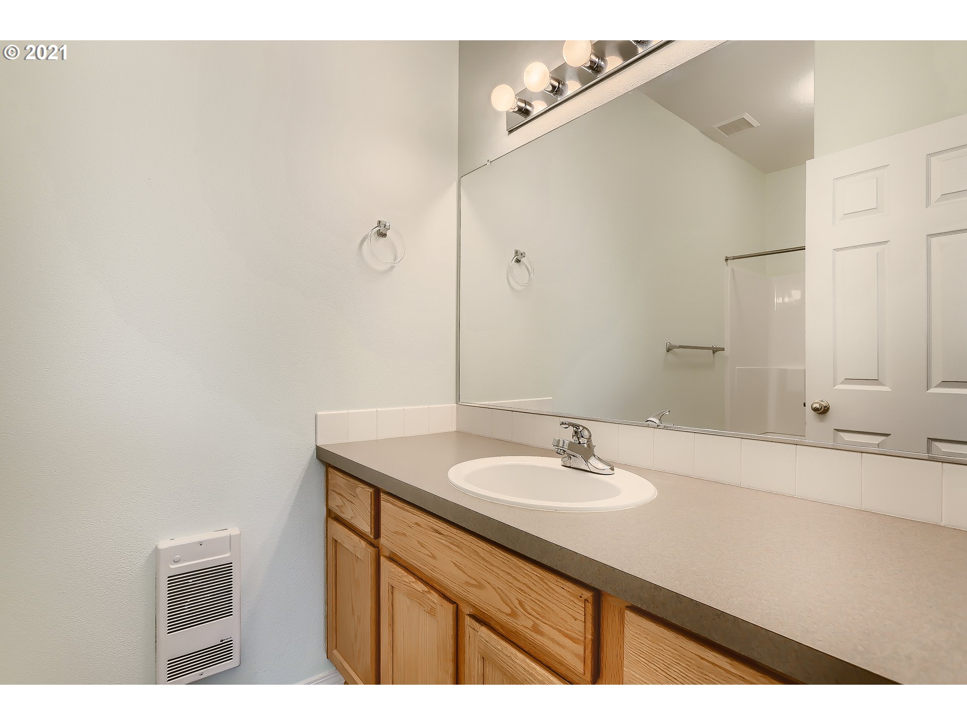 7152 Southwest Manor Way, Unit F Aloha, OR 97078 - Photo 8 of 28 a bathroom with a sink and a mirror