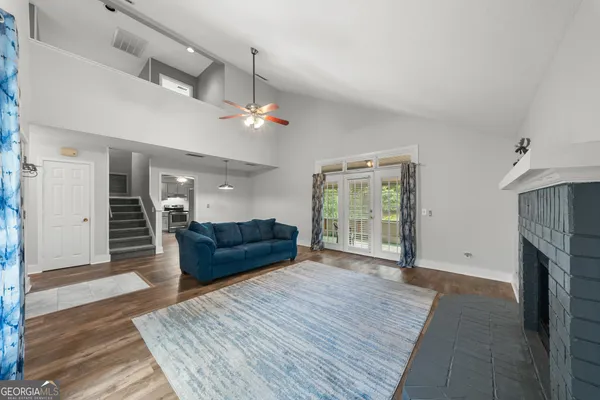 a living room with furniture and a fireplace