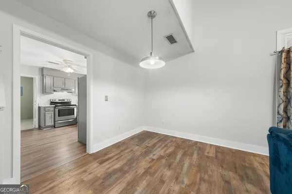 a view of a kitchen with wooden floor