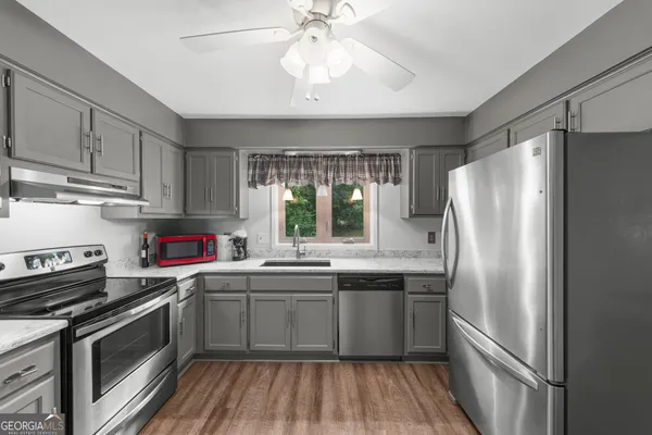 a kitchen with stainless steel appliances a sink stove and refrigerator