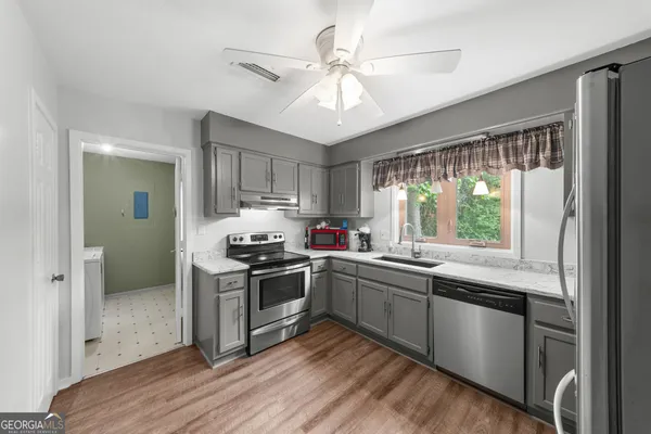 a kitchen with stainless steel appliances granite countertop a stove and a sink