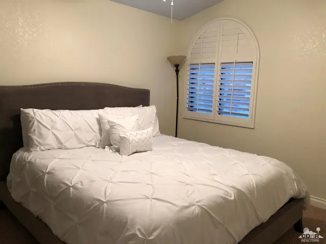 a large white bed in a small room