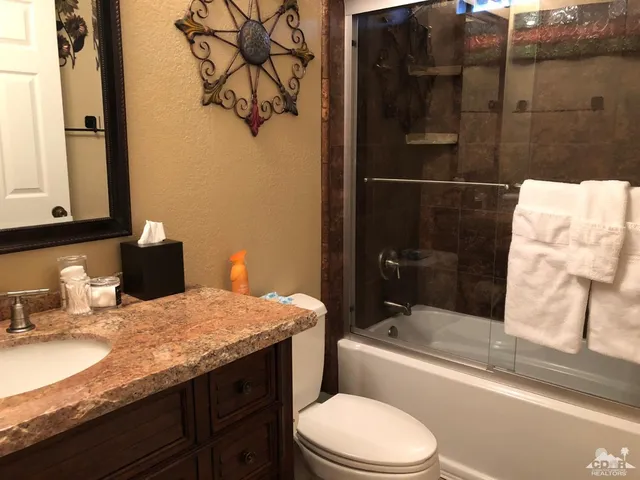 a bedroom with a bed window and a table