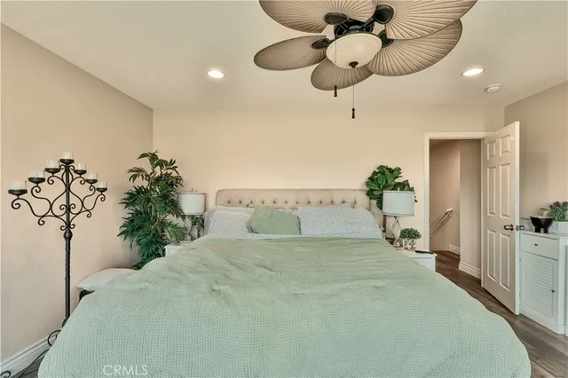 a spacious bedroom with a bed and a chandelier