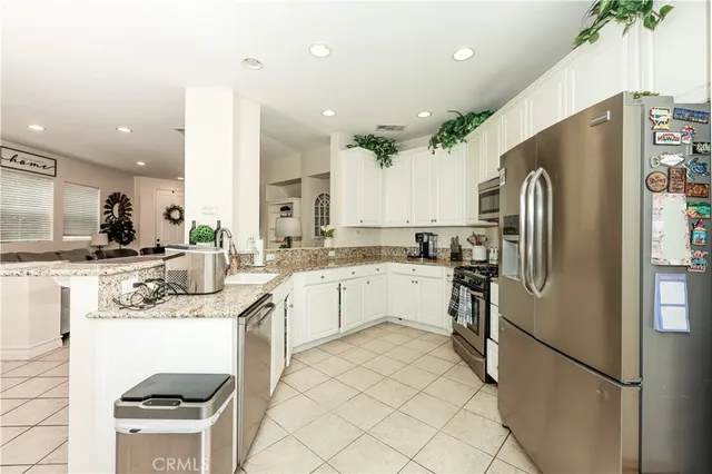 a kitchen with a refrigerator and a sink