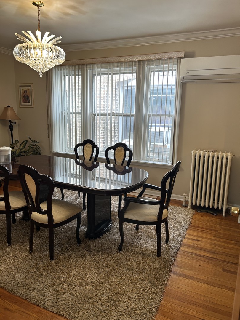 5107 West Cullom Avenue, Unit 2 Chicago, IL 60641 - Photo 5 of 20 a view of a dining room with furniture window and outside view