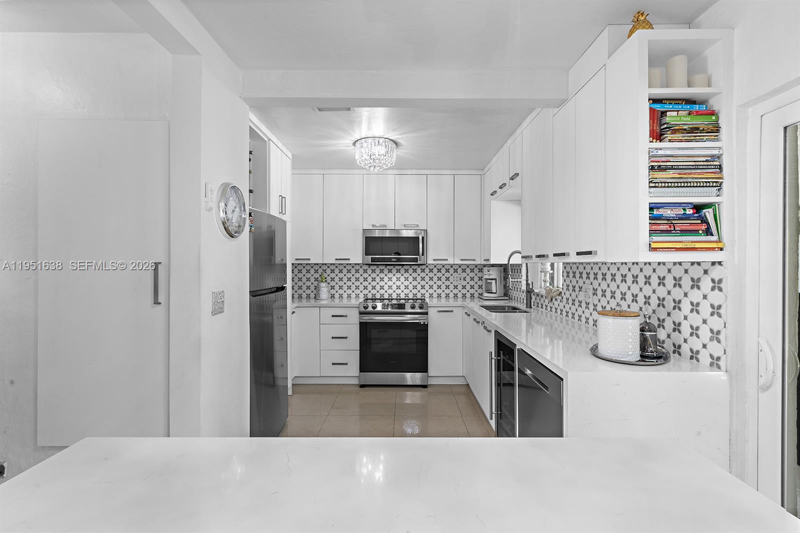 4331 Southwest 7th Street Miami, FL 33134 - Photo 11 of 46 a kitchen with granite countertop a stove oven and sink