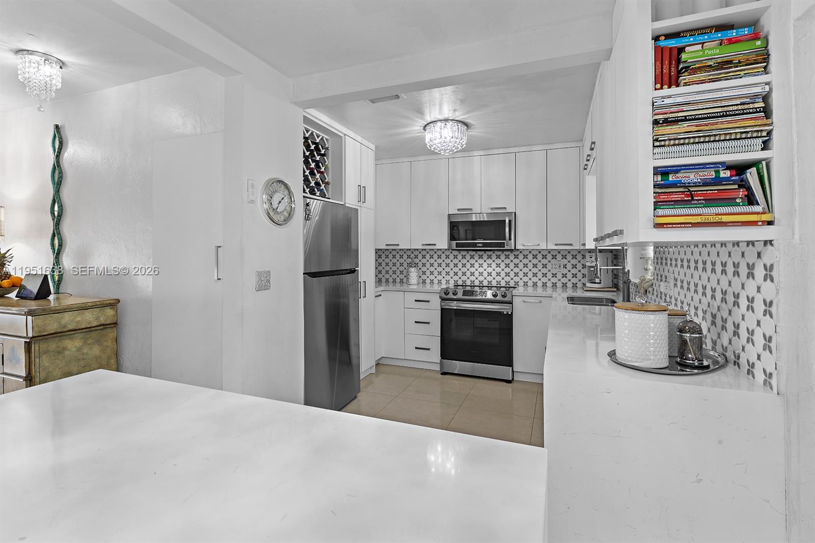 4331 Southwest 7th Street Miami, FL 33134 - Photo 12 of 46 a kitchen with kitchen island a stove a refrigerator and a sink