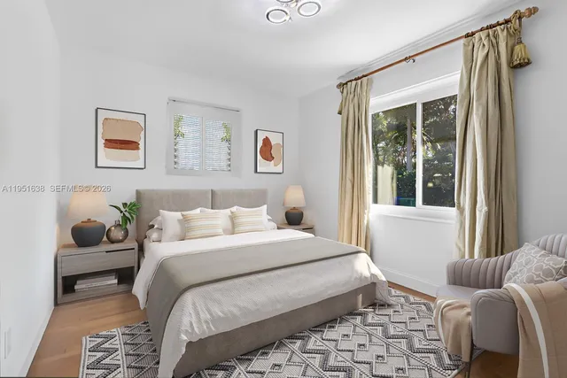 a bedroom with a large bed and a window