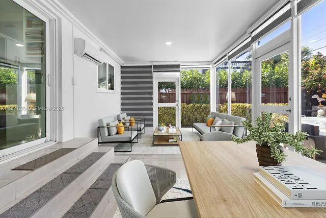 a living room with furniture and next to a window
