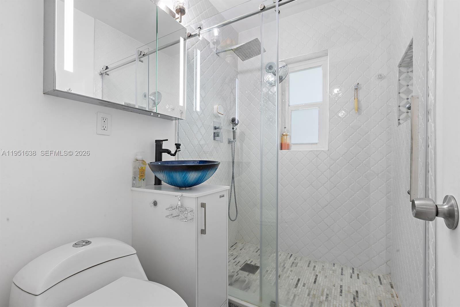 4331 Southwest 7th Street Miami, FL 33134 - Photo 28 of 46 a bathroom with a sink a toilet and shower