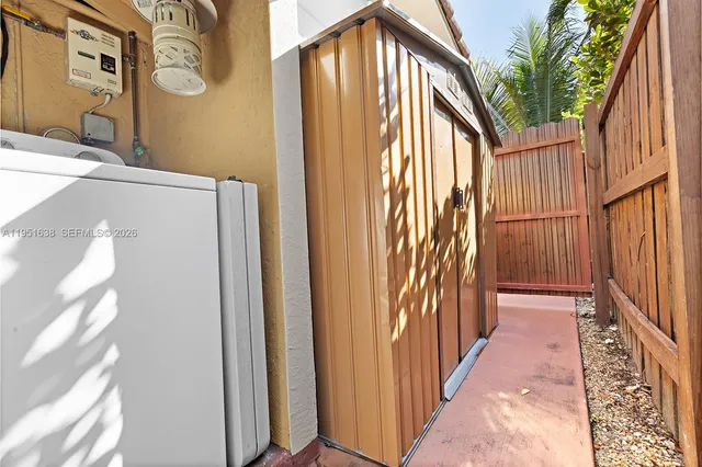 a view of a bedroom with wooden floor and a chair