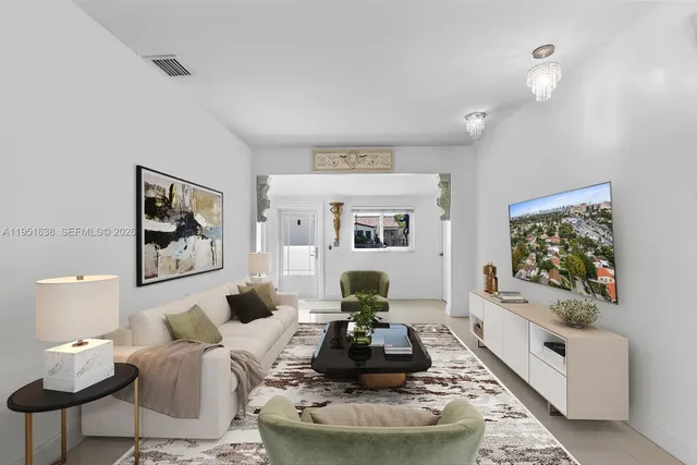 a open kitchen with stainless steel appliances granite countertop a stove oven and a refrigerator with white cabinets