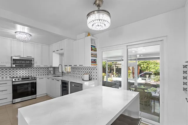 a kitchen with granite countertop a stove oven and sink