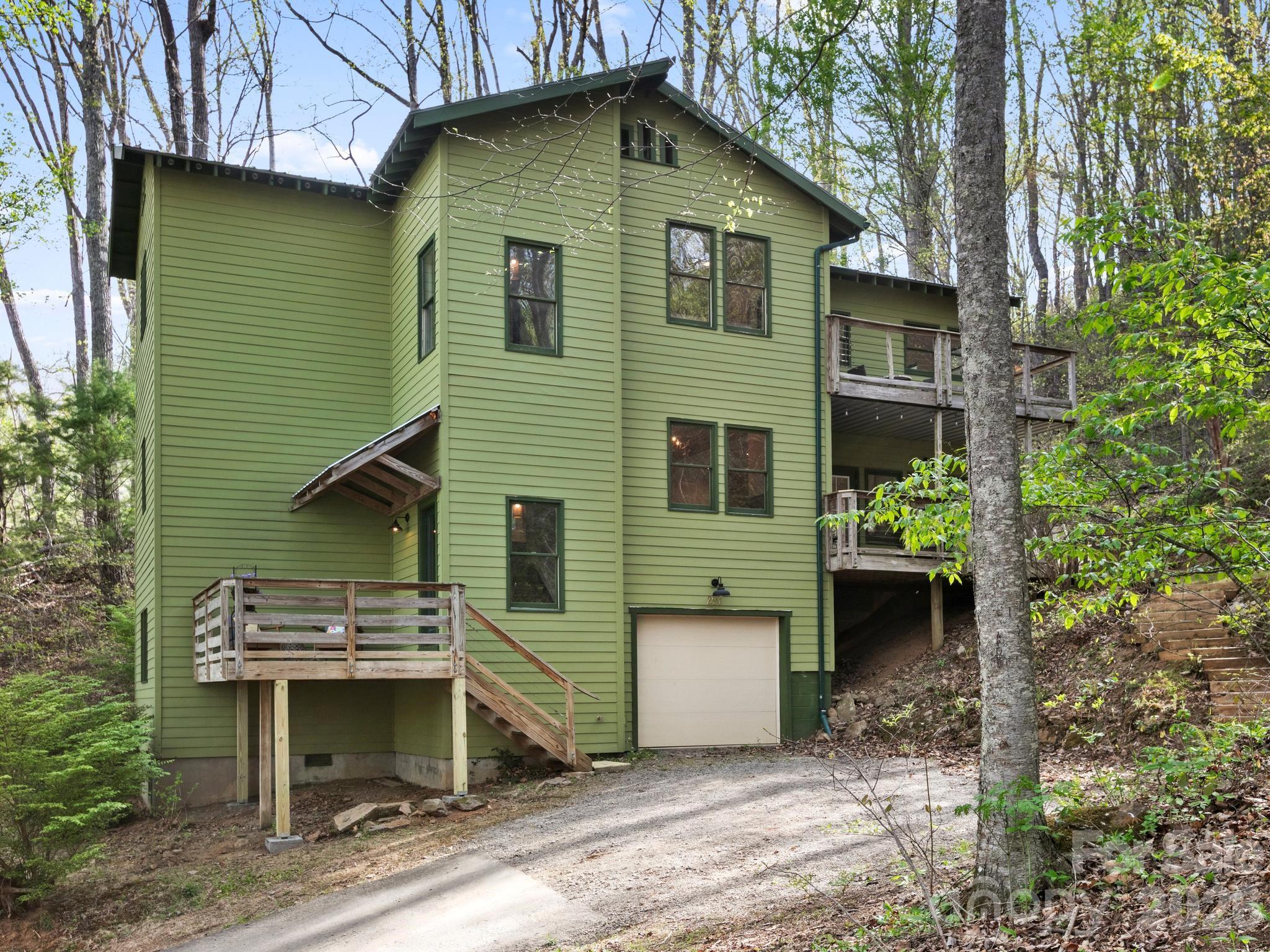 291 Webb Cove Road Asheville, NC 28804 - Photo 1 of 34 a view of a house with a yard and furniture