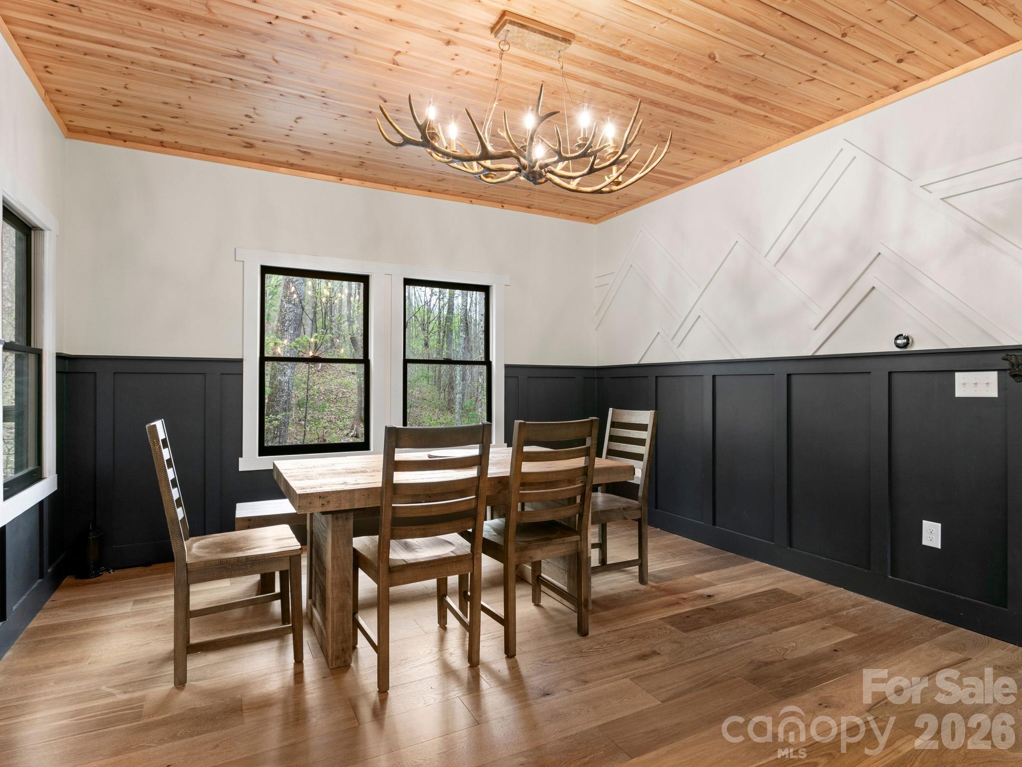 291 Webb Cove Road Asheville, NC 28804 - Photo 12 of 34 a view of a dining room with furniture window and wooden floor