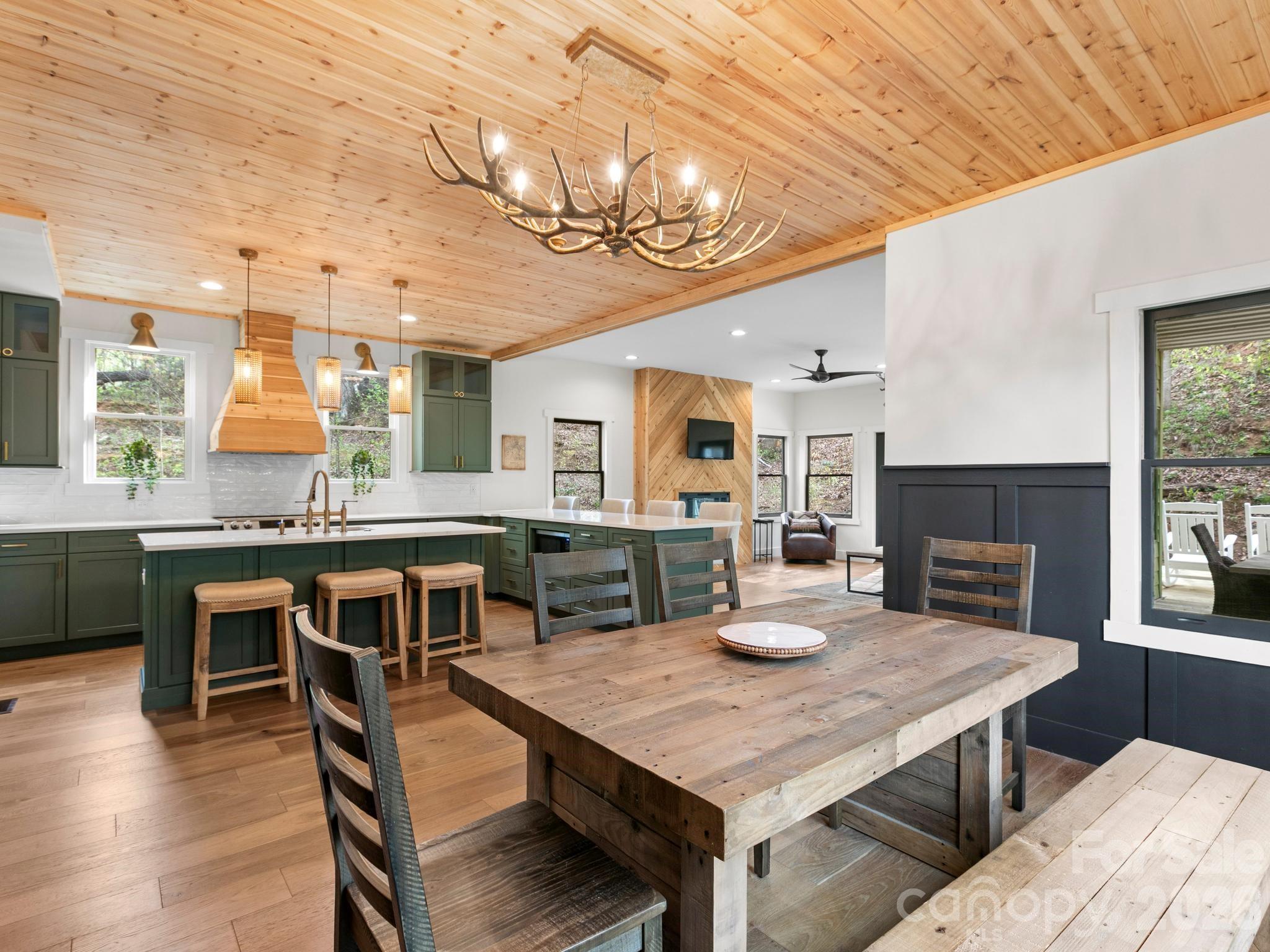 291 Webb Cove Road Asheville, NC 28804 - Photo 13 of 34 a view of a dining room with furniture and wooden floor