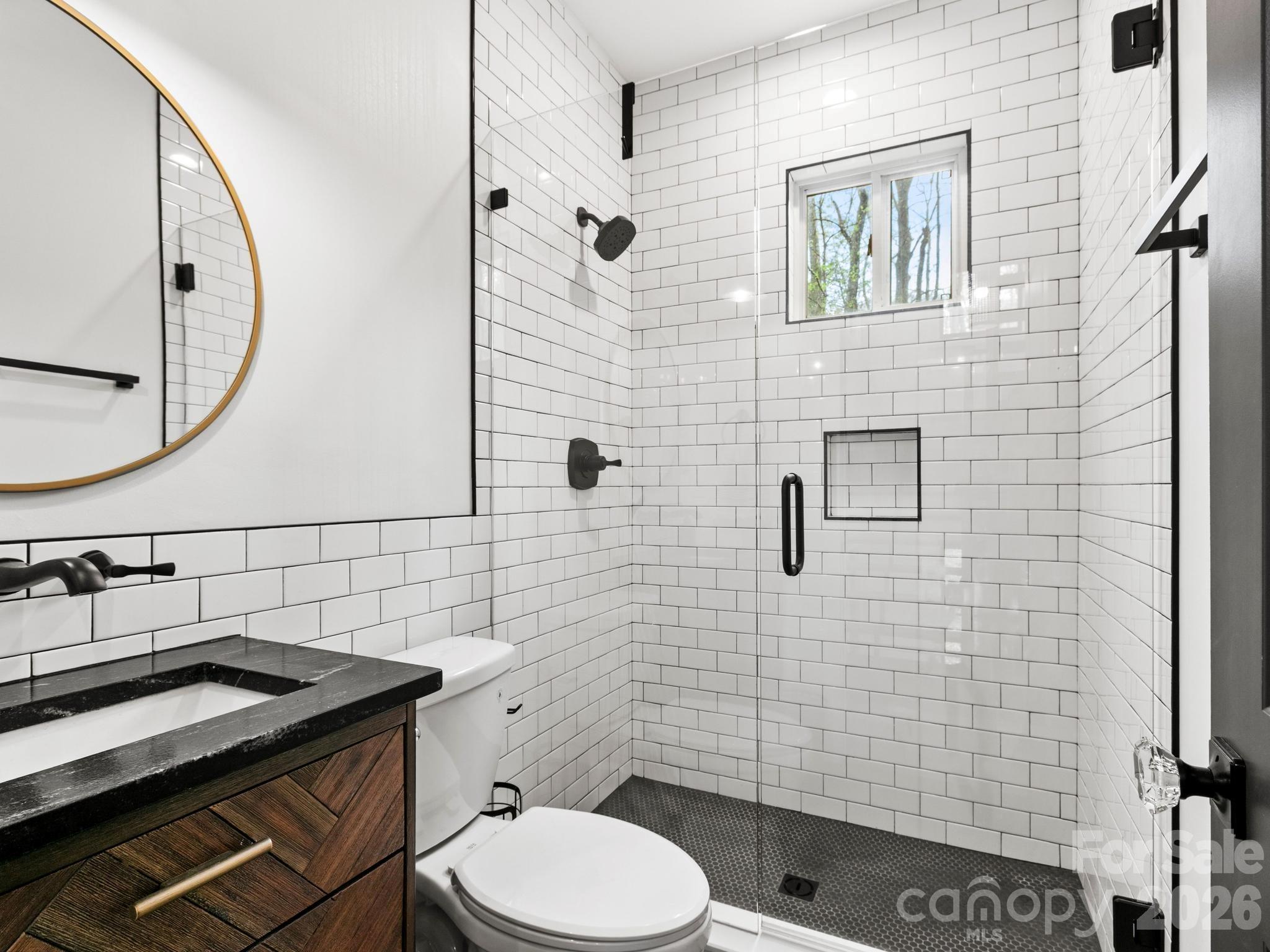 291 Webb Cove Road Asheville, NC 28804 - Photo 15 of 34 a bathroom with a granite countertop toilet sink and mirror