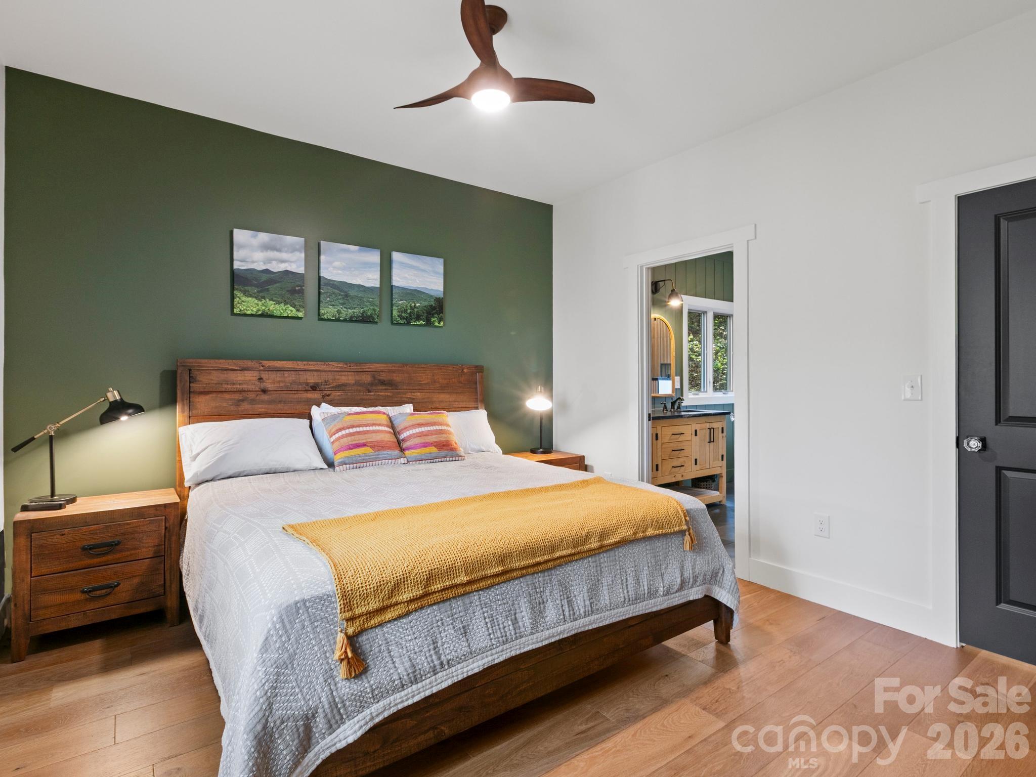 291 Webb Cove Road Asheville, NC 28804 - Photo 17 of 34 a bedroom with a bed and wooden floor