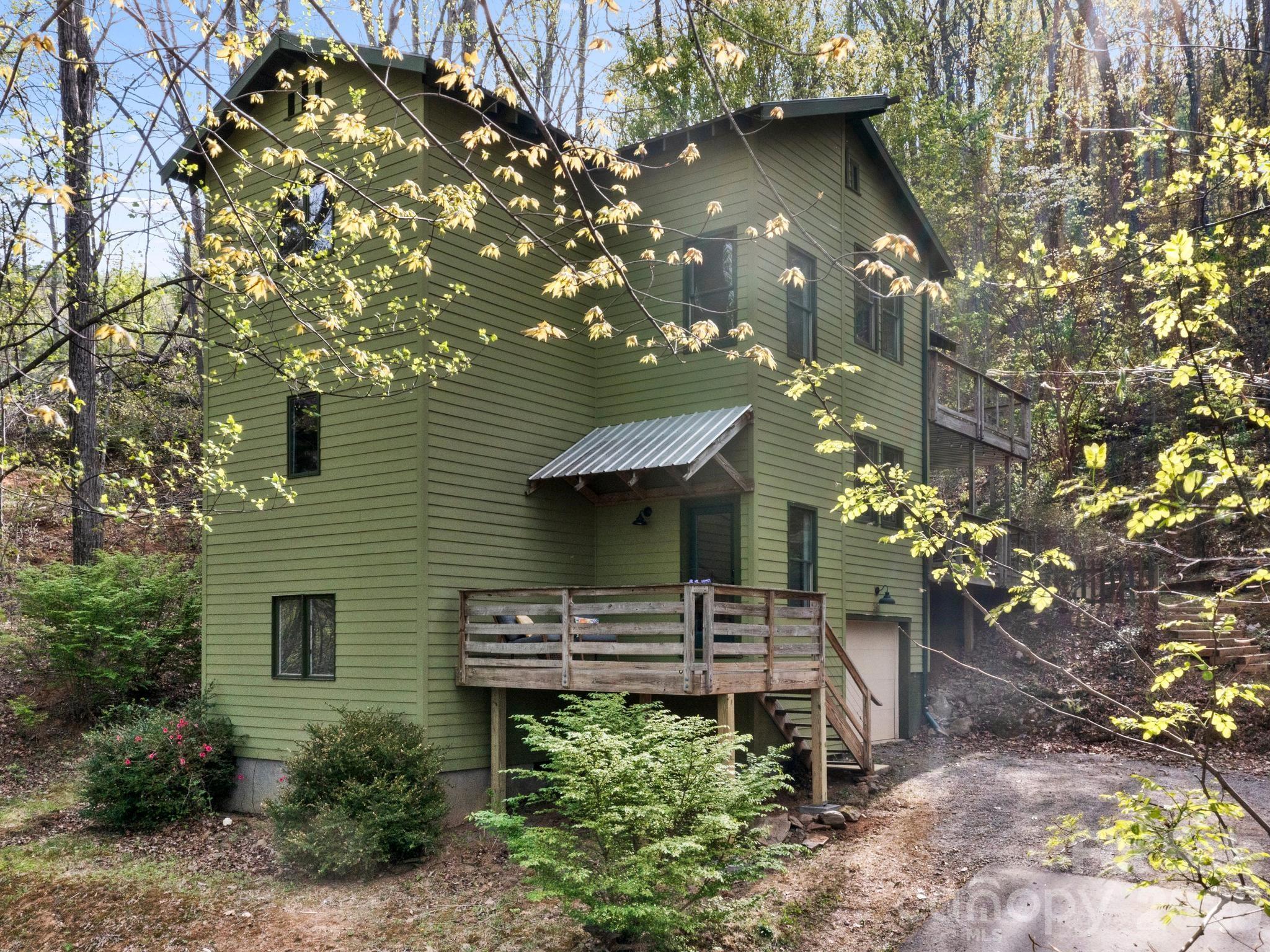 291 Webb Cove Road Asheville, NC 28804 - Photo 2 of 34 a front view of a house with a garden