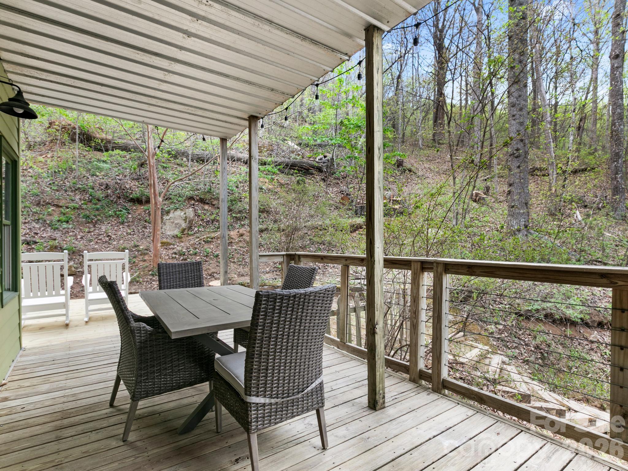 291 Webb Cove Road Asheville, NC 28804 - Photo 25 of 34 a view of a porch with furniture and wooden floor