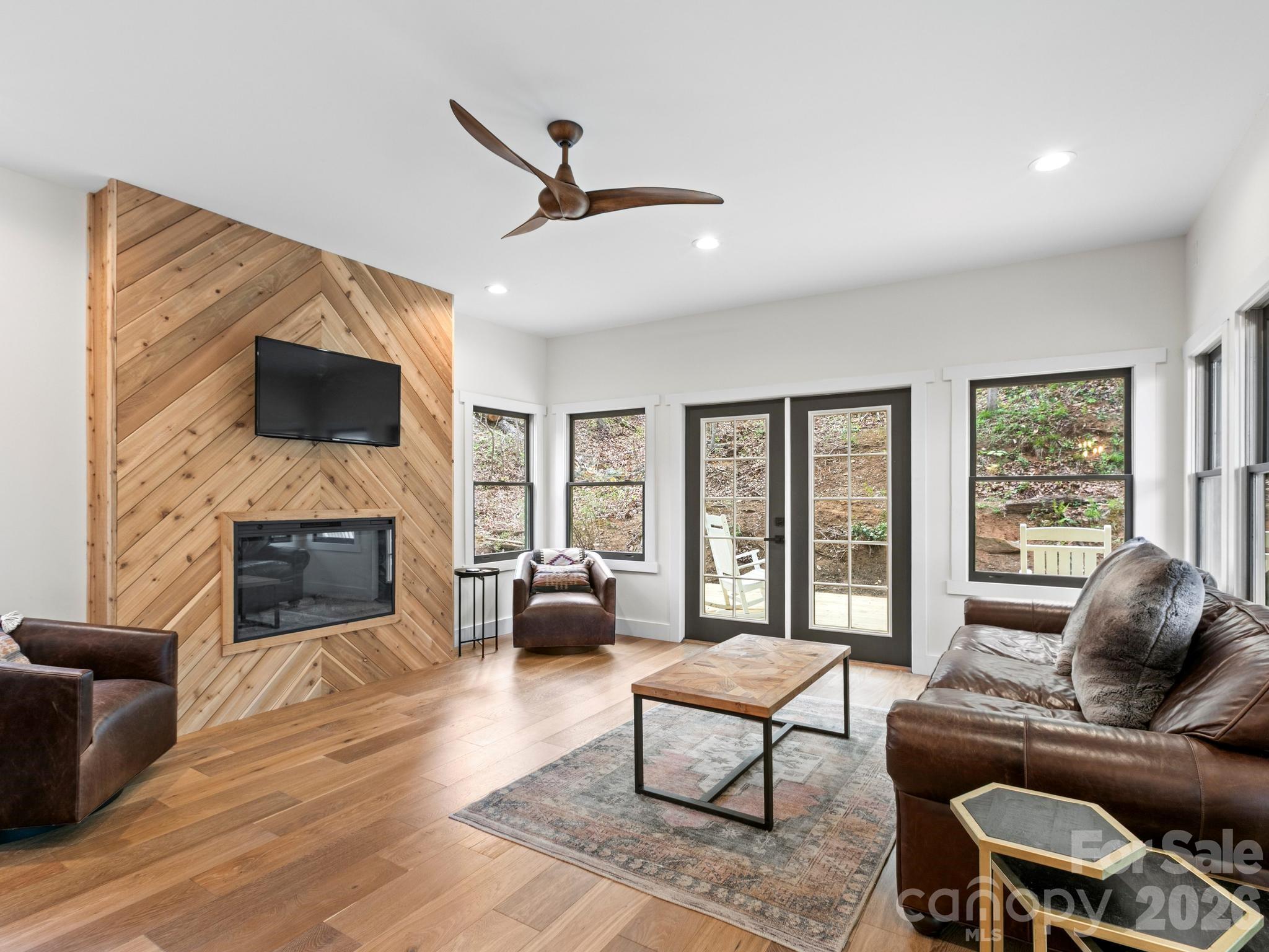 291 Webb Cove Road Asheville, NC 28804 - Photo 4 of 34 a living room with furniture a fireplace and a flat screen tv